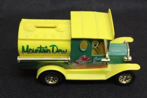 lot 247 image: VINTAGE MOUNTAIN DEW GOLDEN DIE CAST COIN BANK