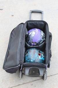 lot 21 image: 2 EBONITE BOWLING BALLS IN STRIKE-FORCE ROLLING BAG