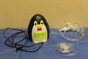 lot 115 image: PEDIATRIC COMPRESSOR NEBULIZER PENGUIN DESIGN