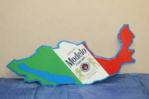 lot 56 image: 2007 BARTON BEERS IMPORTED MODELO ESPECIAL COUNTRY OF MEXICO SHAPED METAL SIGN SIZE 25 LONG
